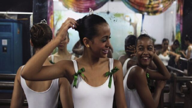 Girls laugh as they wait for their ballet class to start at the ‘Ballet Santa Teresa’ academy in Rio de Janeiro