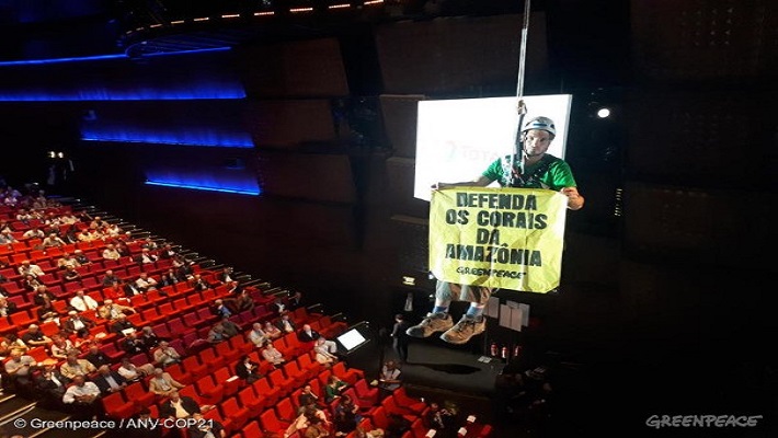 Greenpeace climbers inside Total’s AGM in Paris